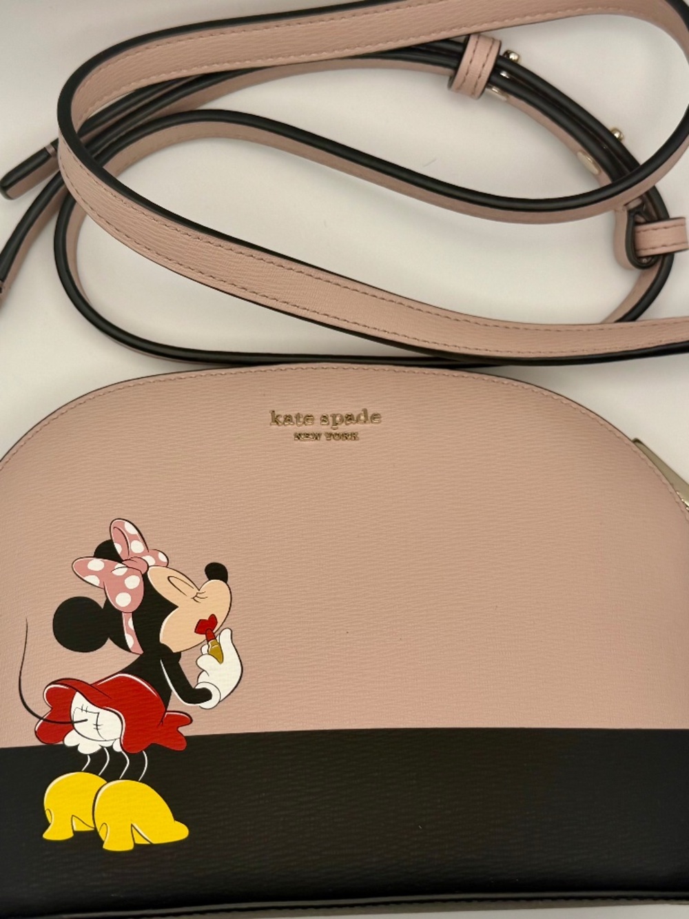Disney Minnie Mouse Dome Crossbody Bag is a medium-sized handbag featuring a zip